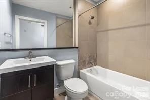 a bathroom with a toilet a sink a mirror and a bathtub