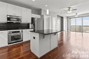 a kitchen with stainless steel appliances a stove top oven a sink and a refrigerator