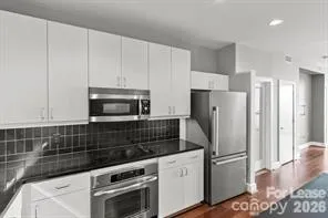 a kitchen with refrigerator and cabinets