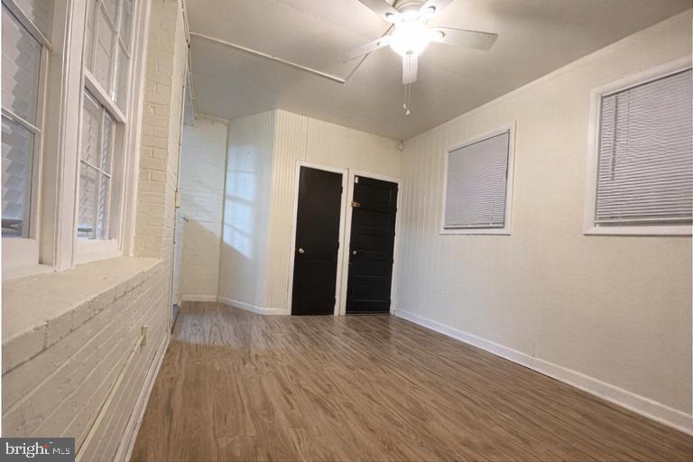 165 35th Street Northeast, Unit 2 Washington, DC 20019 - Photo 12 of 12 a view of an empty room with wooden floor and a window