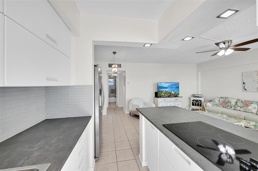 901 South Surf Road, Unit 203 Hollywood, FL 33019 - Photo 11 of 23 a kitchen with stainless steel appliances granite countertop a sink a stove and a refrigerator