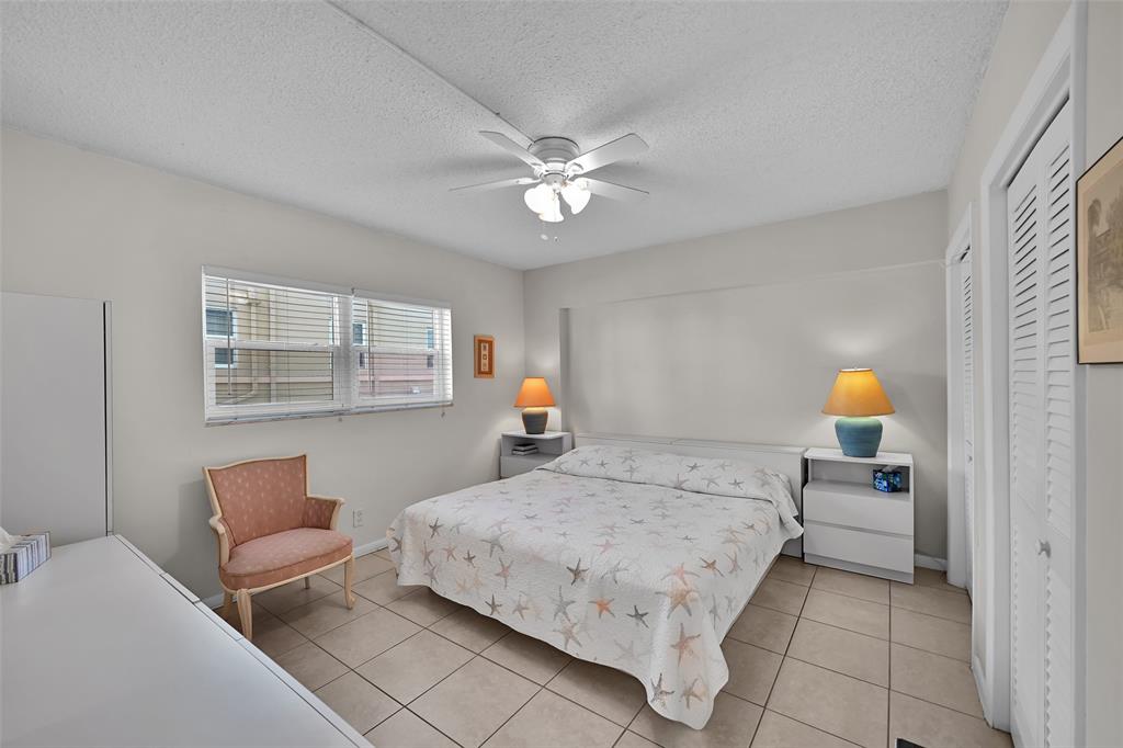 901 South Surf Road, Unit 203 Hollywood, FL 33019 - Photo 12 of 23 a bedroom with a bed couch and window