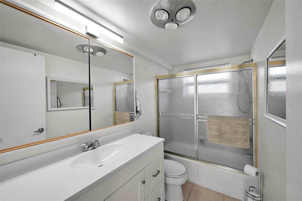 901 South Surf Road, Unit 203 Hollywood, FL 33019 - Photo 13 of 23 a bathroom with a shower sink vanity mirror and toilet
