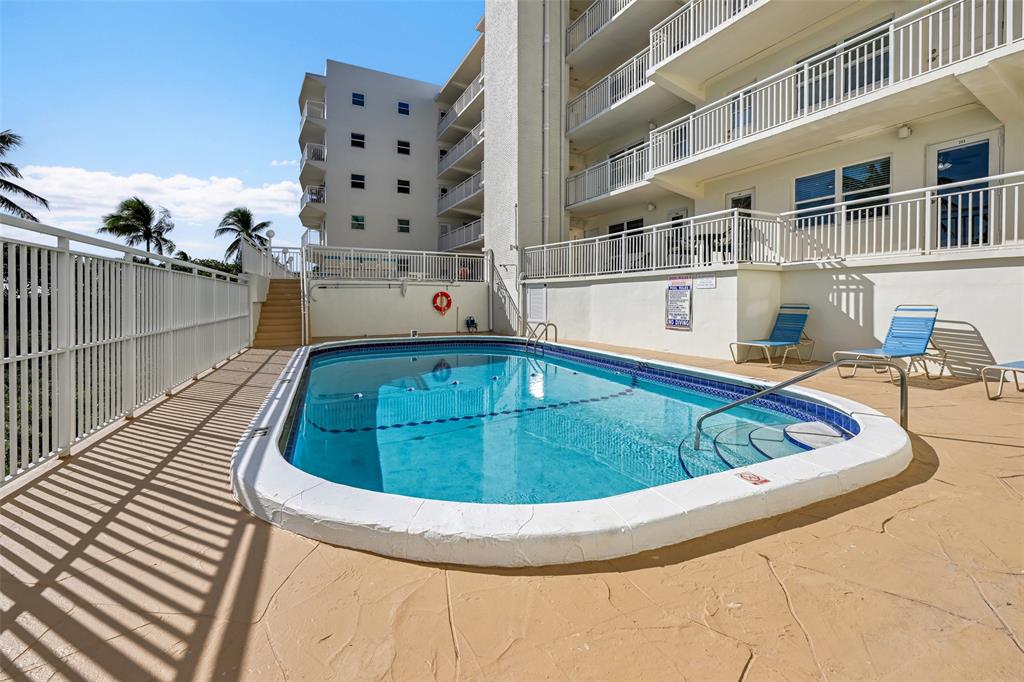 901 South Surf Road, Unit 203 Hollywood, FL 33019 - Photo 19 of 23 a view of swimming pool with a lounge chairs
