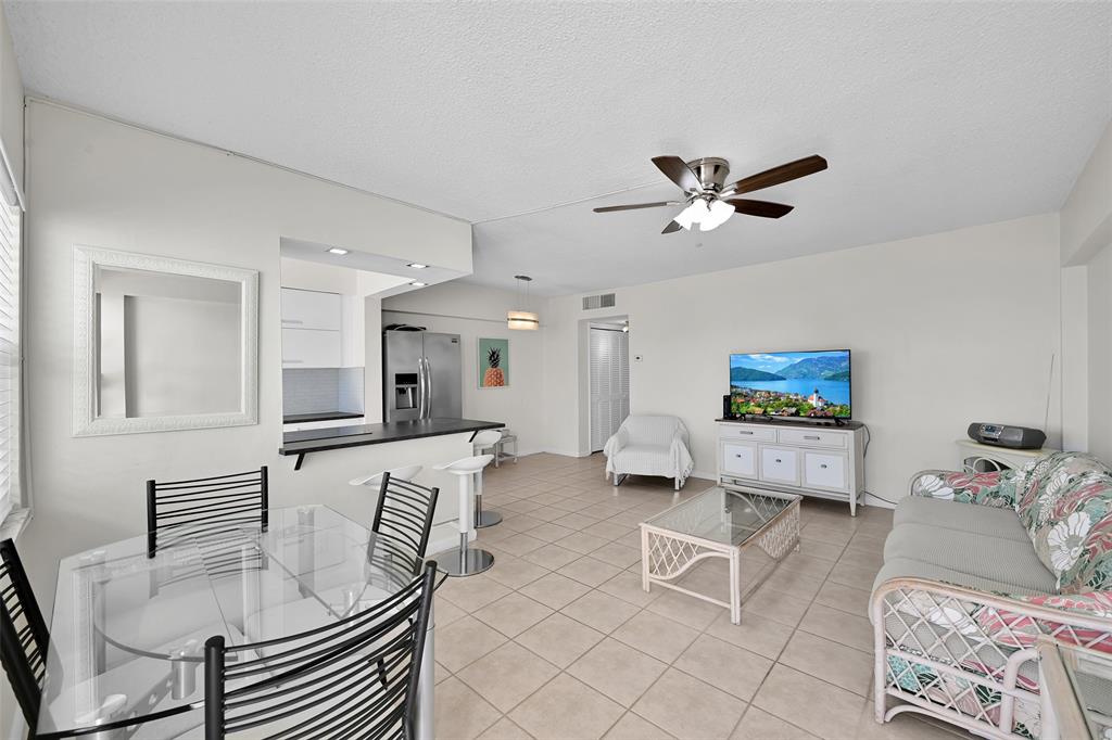 901 South Surf Road, Unit 203 Hollywood, FL 33019 - Photo 3 of 23 a living room with furniture and a flat screen tv