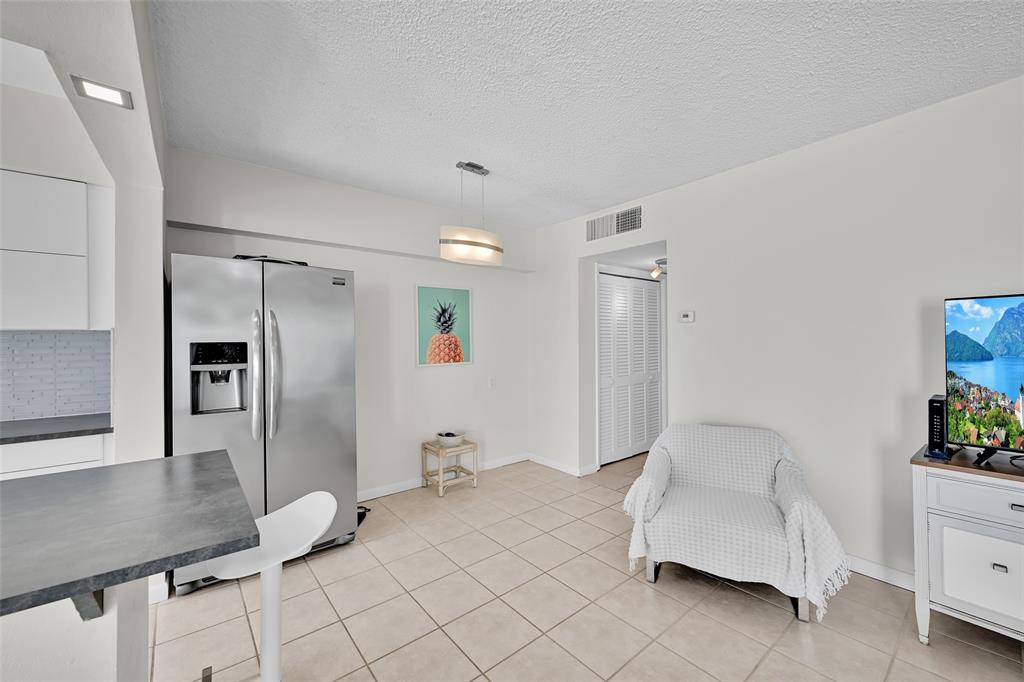 901 South Surf Road, Unit 203 Hollywood, FL 33019 - Photo 6 of 23 a spacious bedroom with a bed and a couch