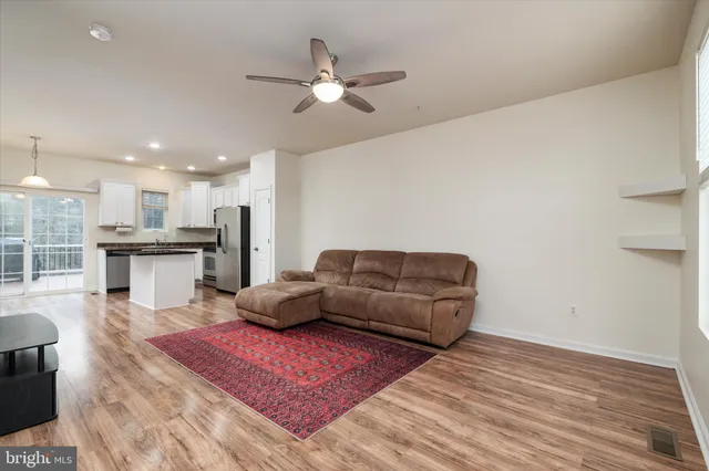 a living room with furniture and kitchen view