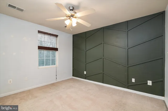 a view of a livingroom with a ceiling fan and window
