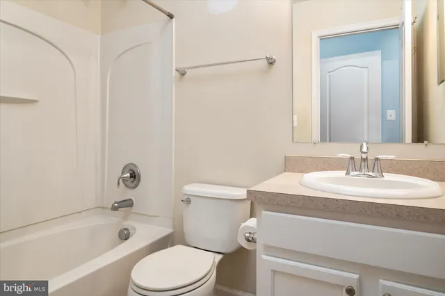 a bathroom with a sink toilet vanity and shower