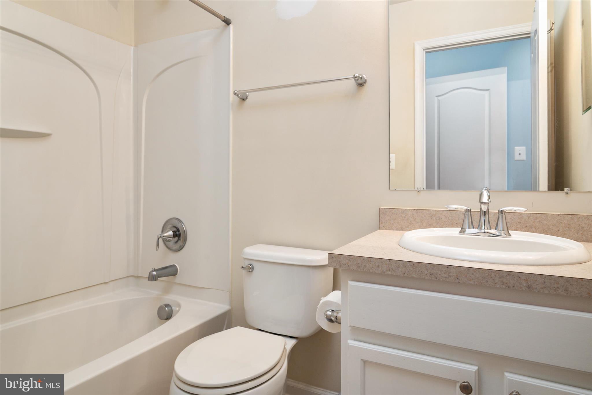 1013 Sithean Way Glen Burnie, MD 21060 - Photo 23 of 35 a bathroom with a sink toilet vanity and shower