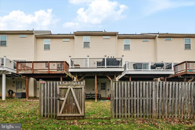 a view of a house with a wooden deck