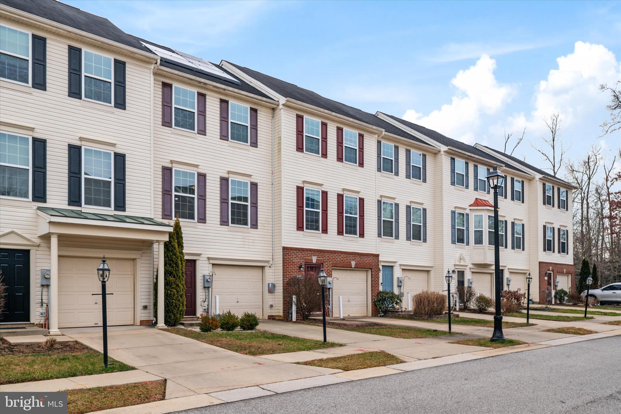 1013 Sithean Way Glen Burnie, MD 21060 - Photo 3 of 35 a front view of a building with a garden