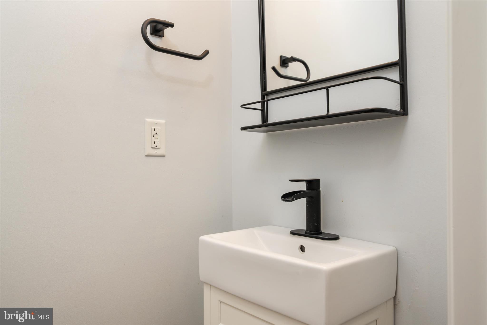 1013 Sithean Way Glen Burnie, MD 21060 - Photo 5 of 35 a bathroom with a sink and mirror