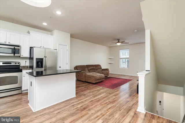 a kitchen with sink refrigerator and microwave