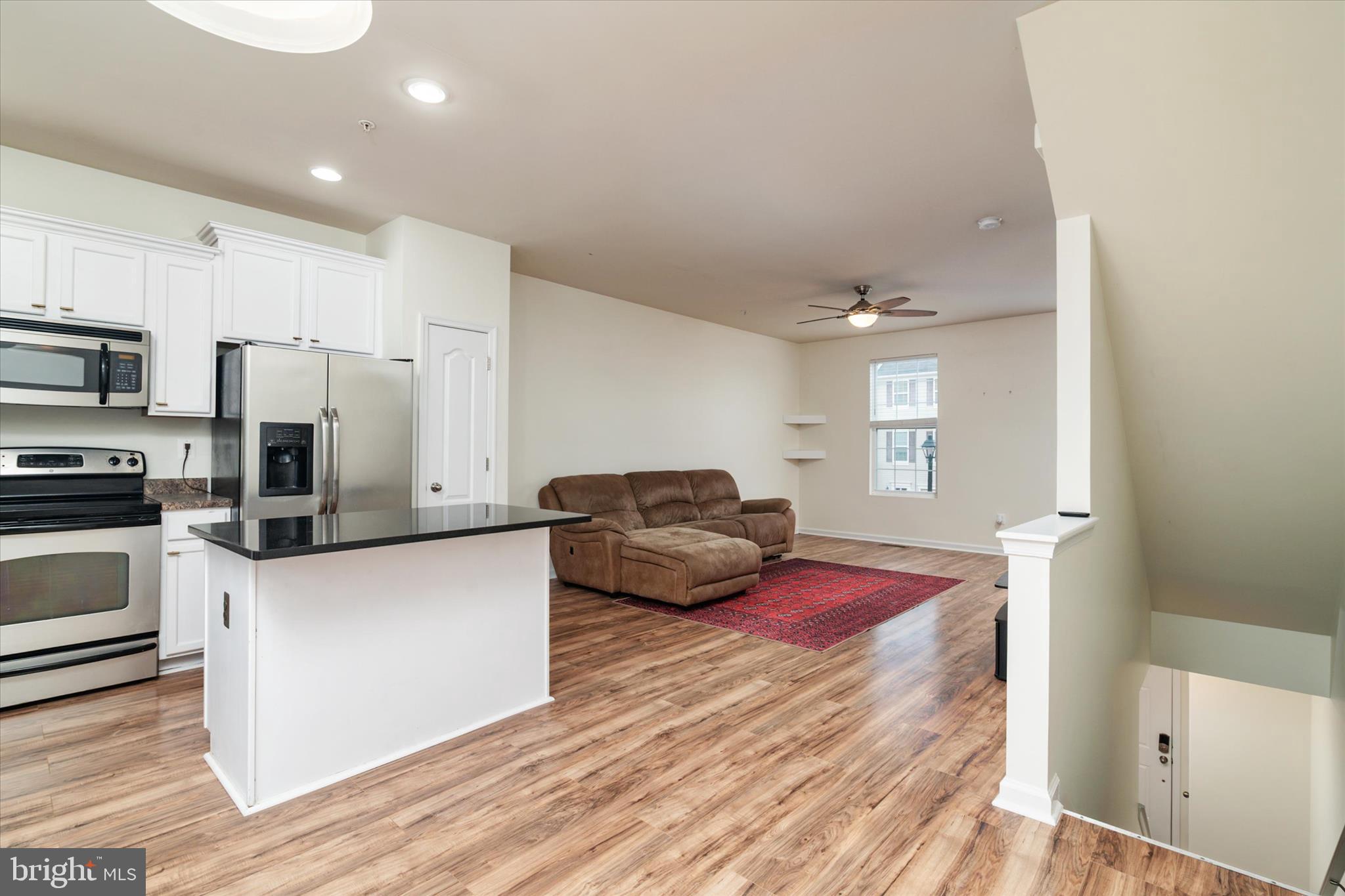 1013 Sithean Way Glen Burnie, MD 21060 - Photo 10 of 35 a kitchen with sink refrigerator and microwave