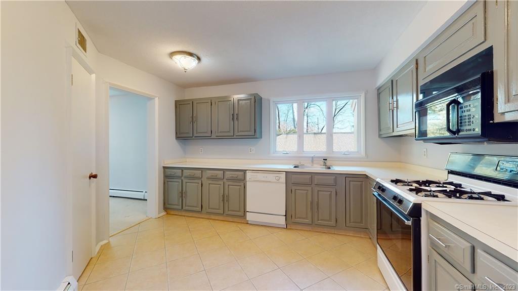 4 Talcott Glen Road, Unit G Farmington, CT 06032 - Photo 1 of 1 a kitchen with stainless steel appliances granite countertop a stove sink and cabinets