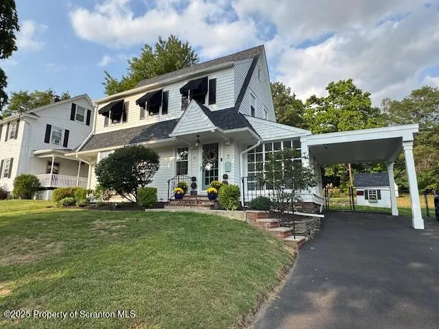 a front view of a house with garden and porch