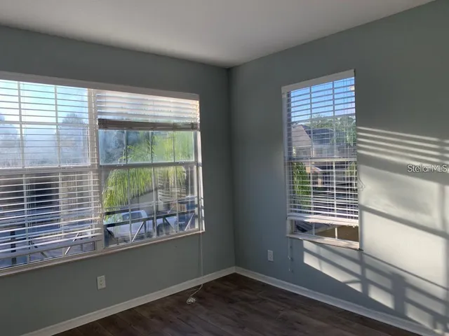 a view of a room with wooden floor and a window