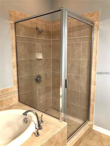 a bathroom with a shower and a sink