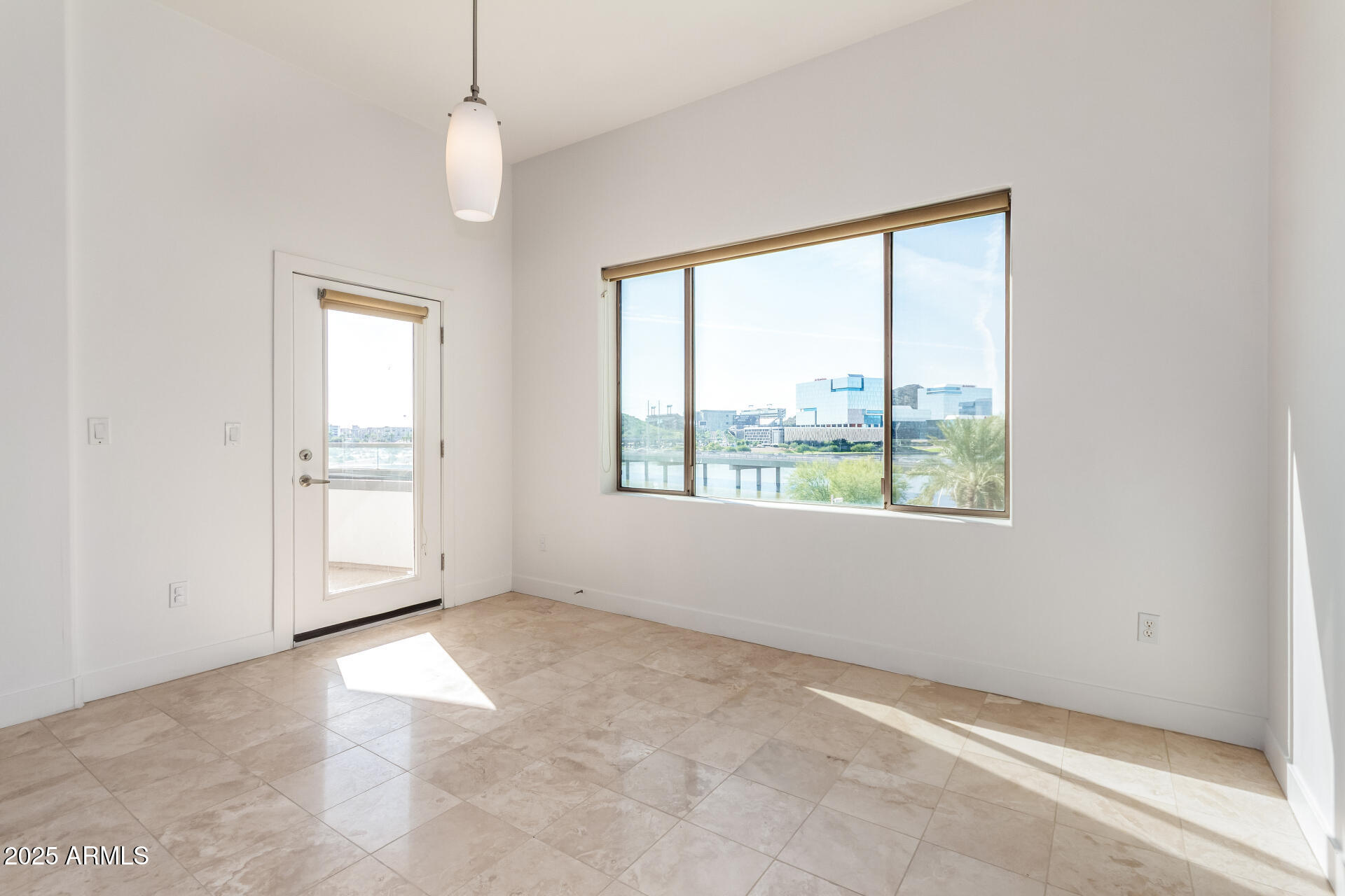 945 East Playa Del Norte Drive, Unit 3013 Tempe, AZ 85288 - Photo 11 of 36 an empty room with windows and chandelier fan