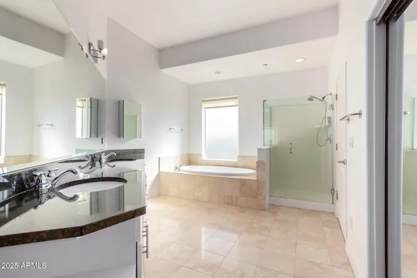 a bathroom with a sink tub shower and a mirror