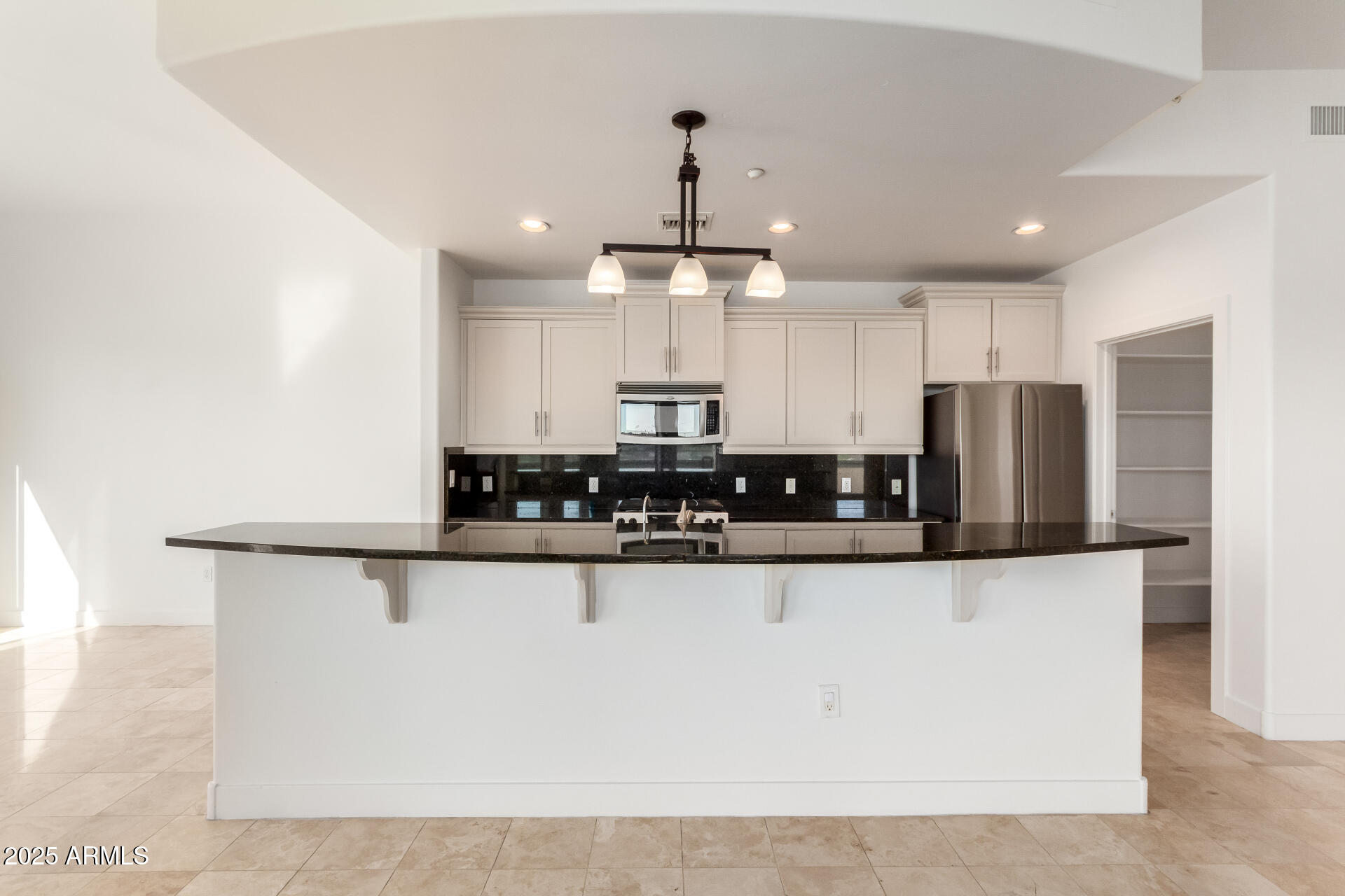 945 East Playa Del Norte Drive, Unit 3013 Tempe, AZ 85288 - Photo 5 of 36 a kitchen with stainless steel appliances granite countertop a sink a stove and a refrigerator