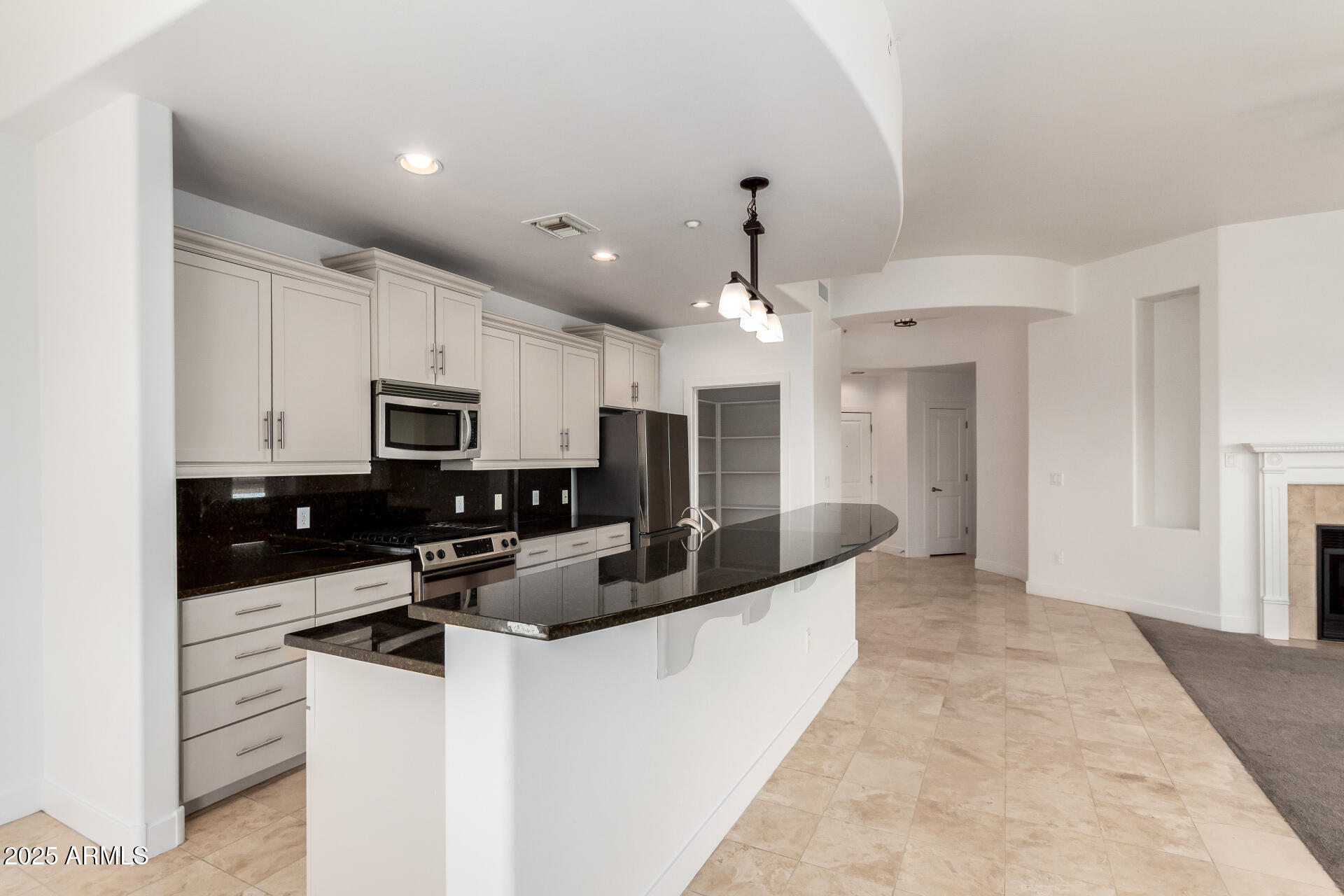 945 East Playa Del Norte Drive, Unit 3013 Tempe, AZ 85288 - Photo 6 of 36 a kitchen with stainless steel appliances a sink stove and cabinets