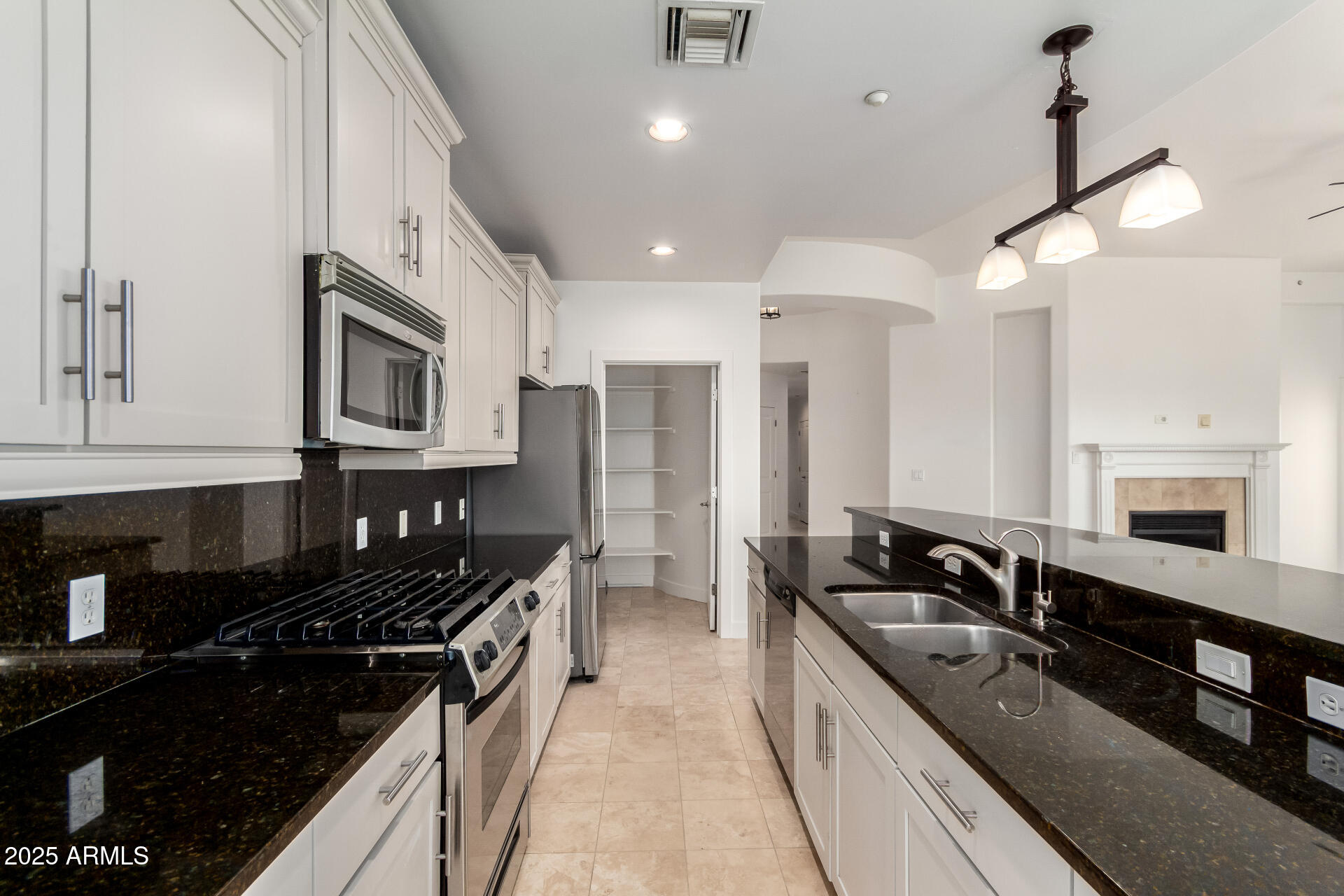 945 East Playa Del Norte Drive, Unit 3013 Tempe, AZ 85288 - Photo 7 of 36 a kitchen with stainless steel appliances a sink stove and cabinets