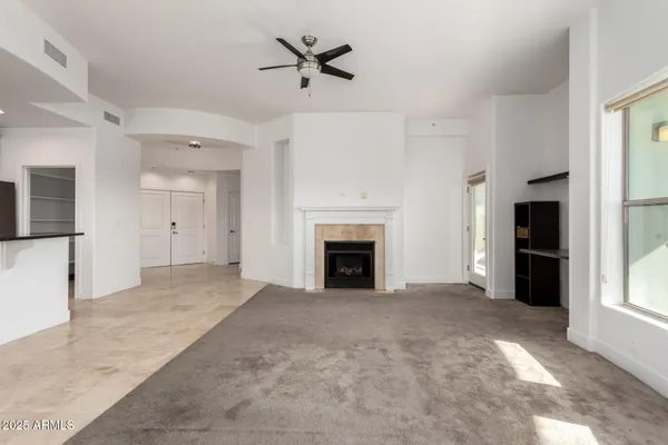 a view of a livingroom with an empty space and a fireplace
