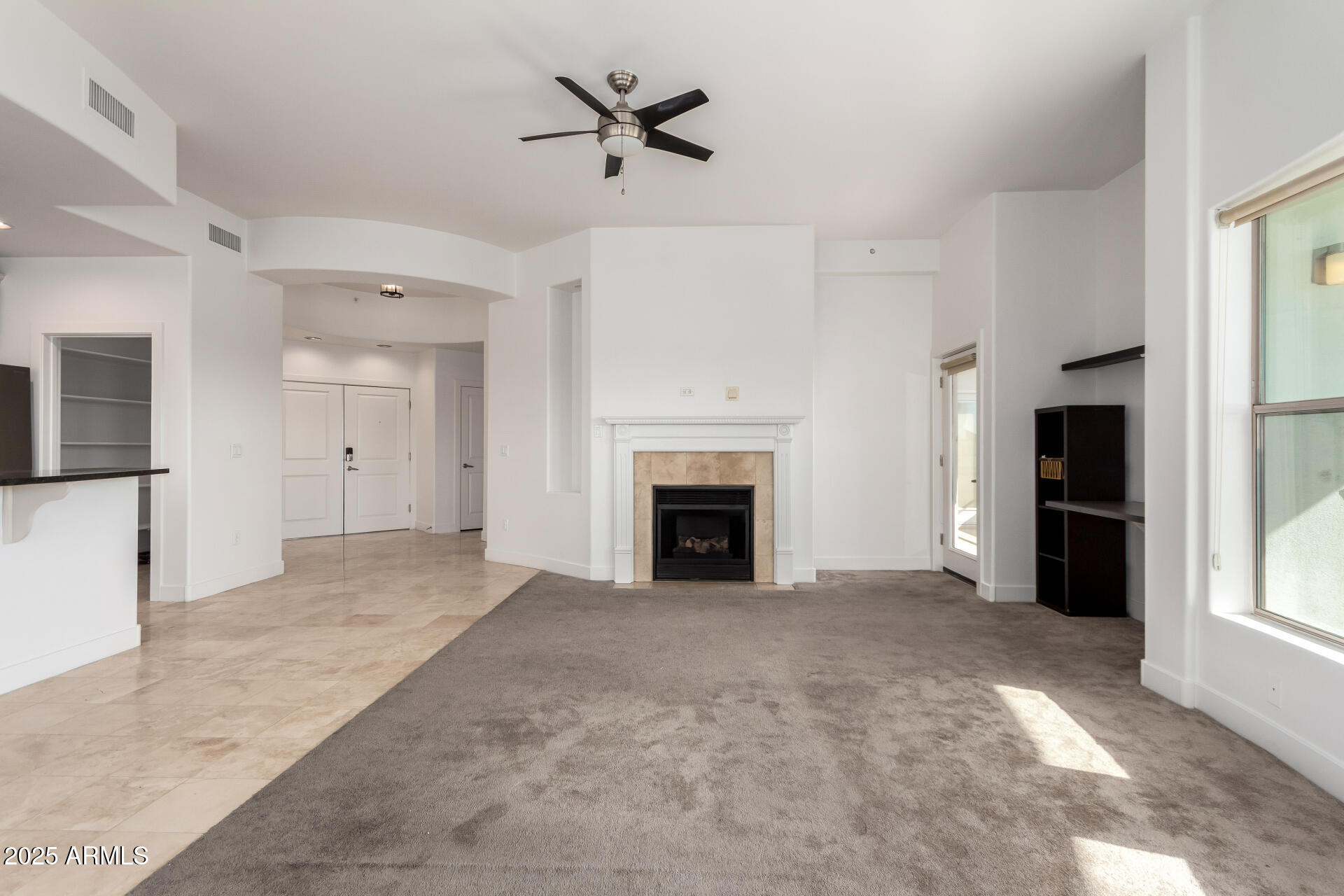 945 East Playa Del Norte Drive, Unit 3013 Tempe, AZ 85288 - Photo 10 of 36 a view of a livingroom with an empty space and a fireplace