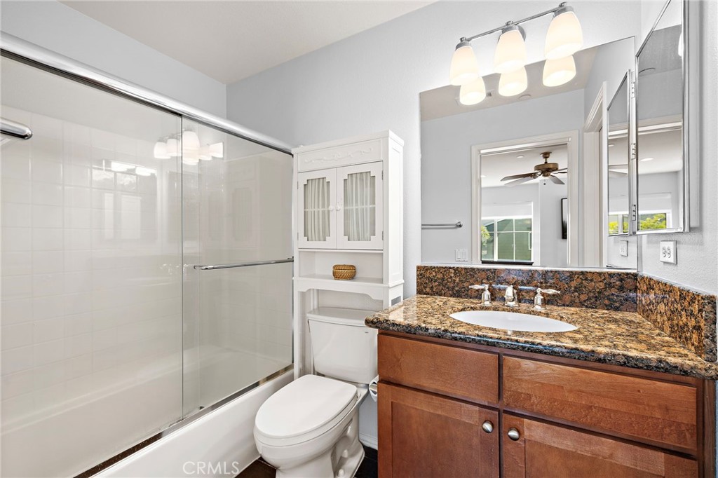 73 Platinum Circle Ladera Ranch, CA 92694 - Photo 12 of 28 a bathroom with a granite countertop sink toilet a mirror a bathtub and shower