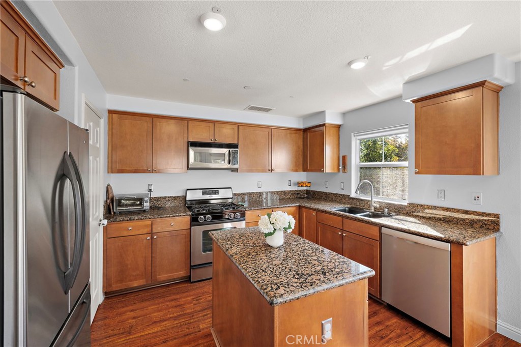 73 Platinum Circle Ladera Ranch, CA 92694 - Photo 6 of 28 a kitchen with stainless steel appliances granite countertop a sink stove and refrigerator