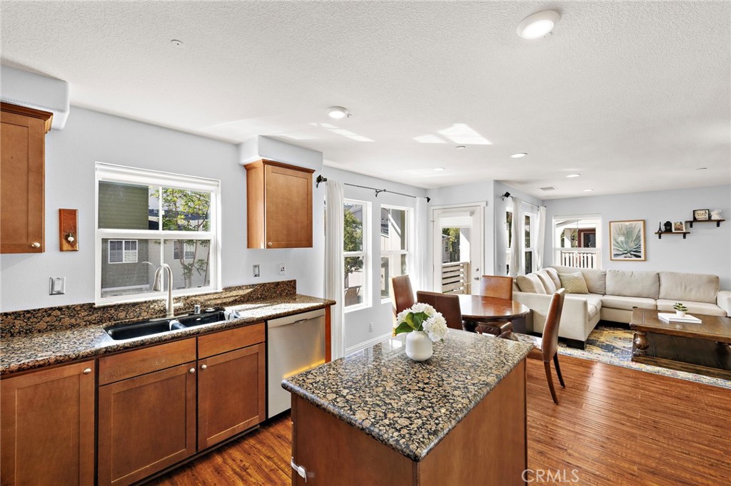 73 Platinum Circle Ladera Ranch, CA 92694 - Photo 7 of 28 a large kitchen with granite countertop a large counter top and dining table