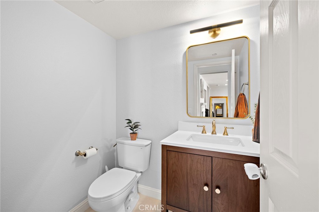 73 Platinum Circle Ladera Ranch, CA 92694 - Photo 8 of 28 a bathroom with a toilet sink and mirror