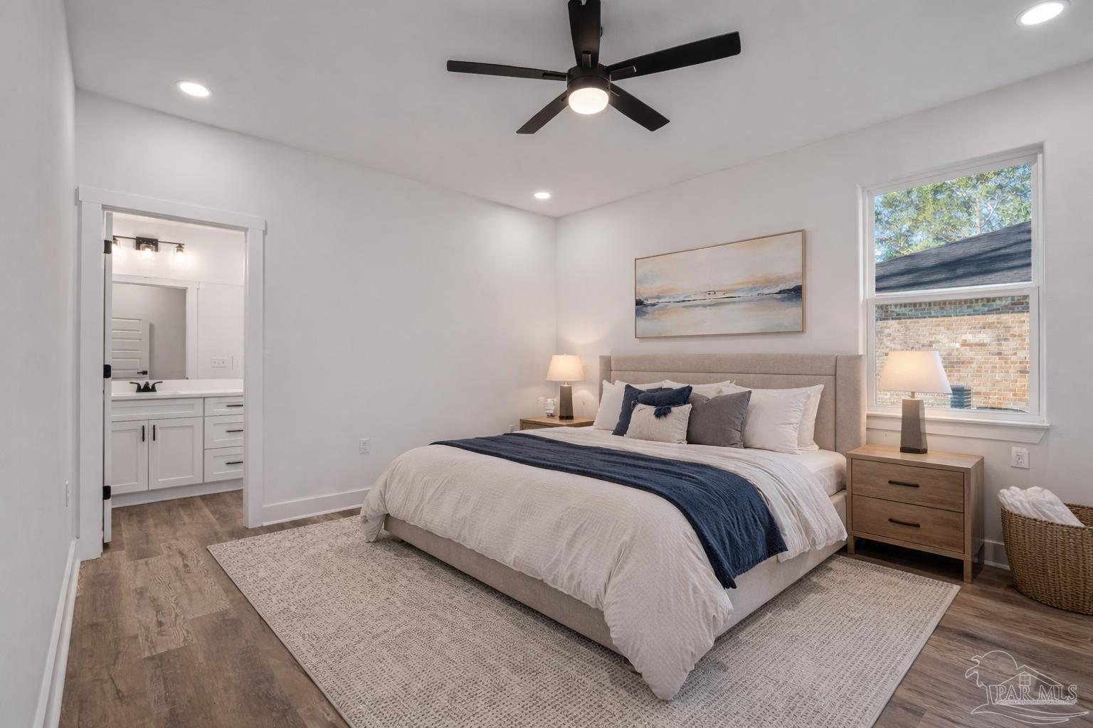 5005 Saufley Field Road Pensacola, FL 32526 - Photo 8 of 27 a bedroom with a large bed and a chandelier