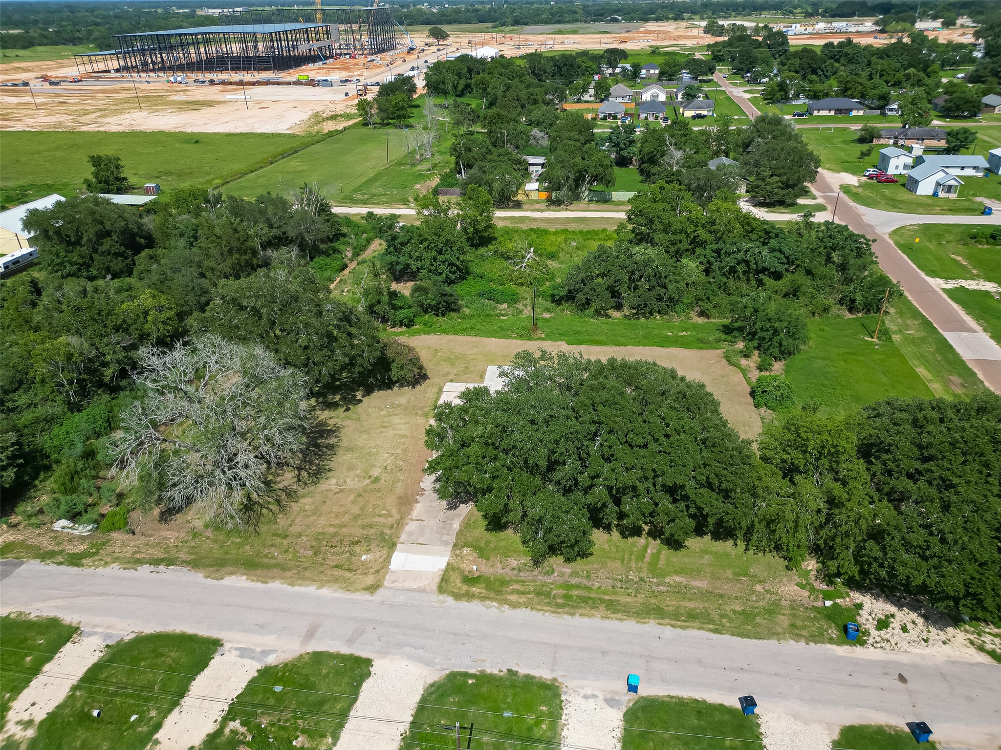 210 5th Street Hempstead, TX 77445 - Photo 18 of 36 an aerial view of residential houses with outdoor space and trees