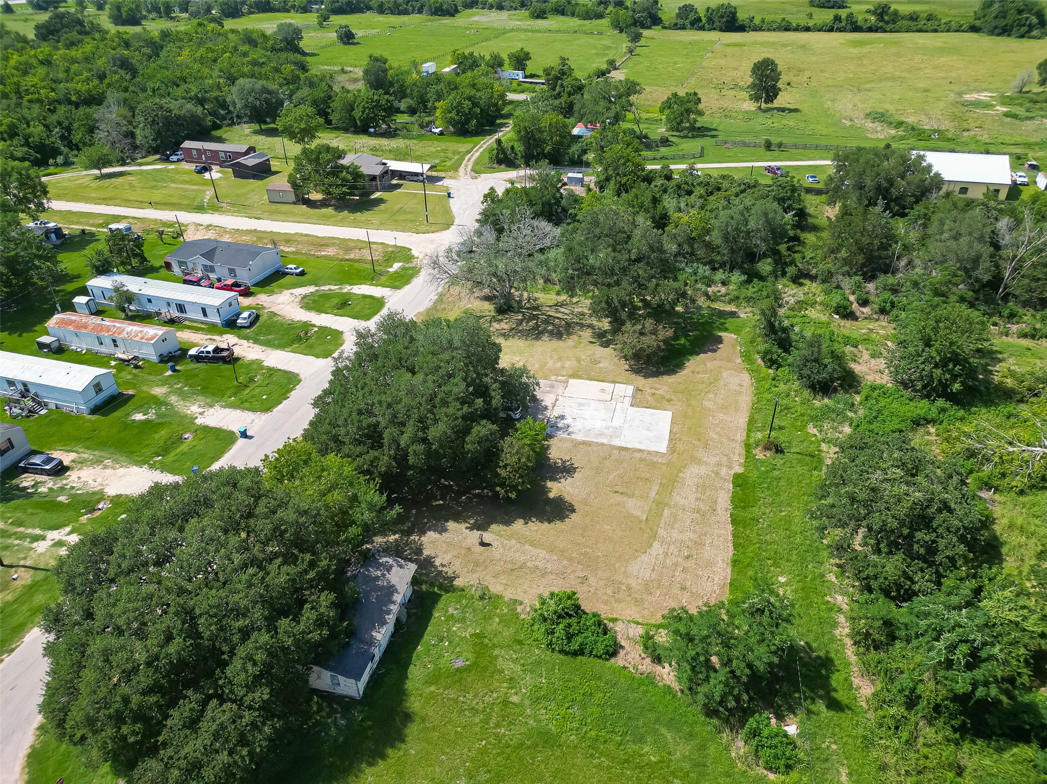 210 5th Street Hempstead, TX 77445 - Photo 22 of 36 an aerial view of a house with a yard and lake view