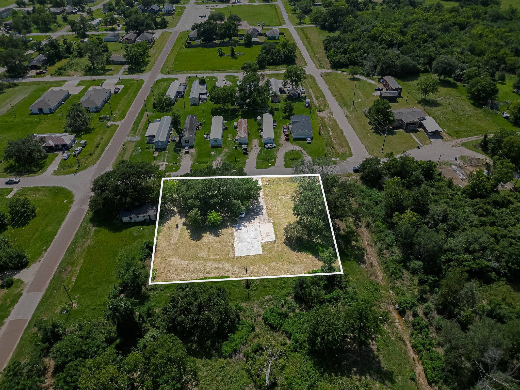 210 5th Street Hempstead, TX 77445 - Photo 24 of 36 an aerial view of a residential houses with outdoor space and street