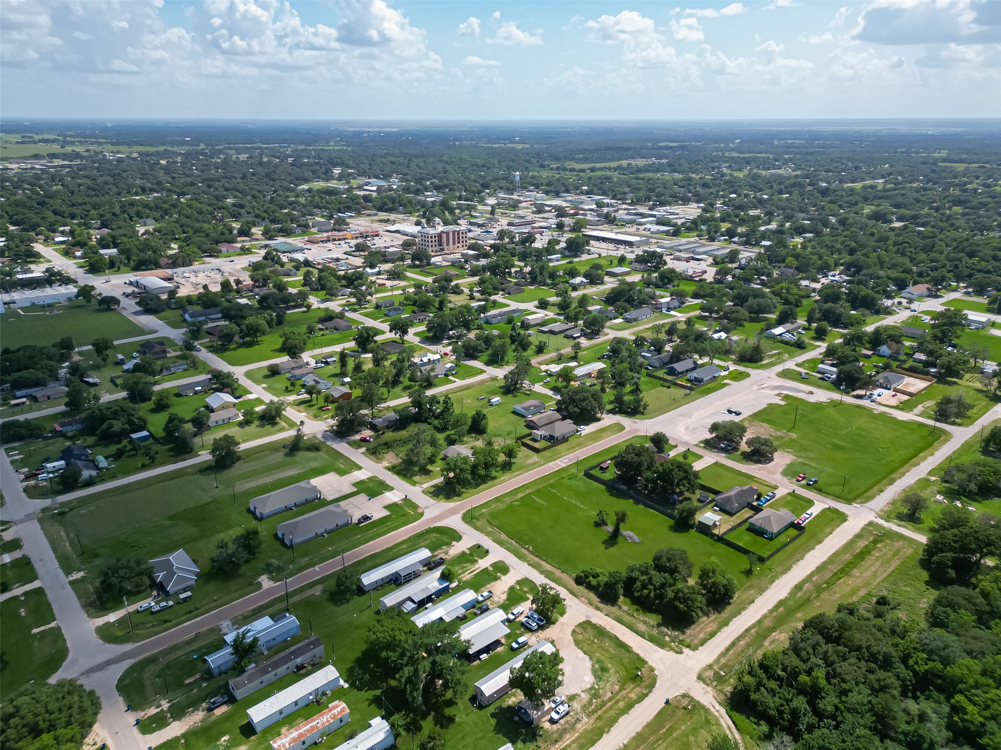 210 5th Street Hempstead, TX 77445 - Photo 31 of 36 an aerial view of residential houses with outdoor space and trees