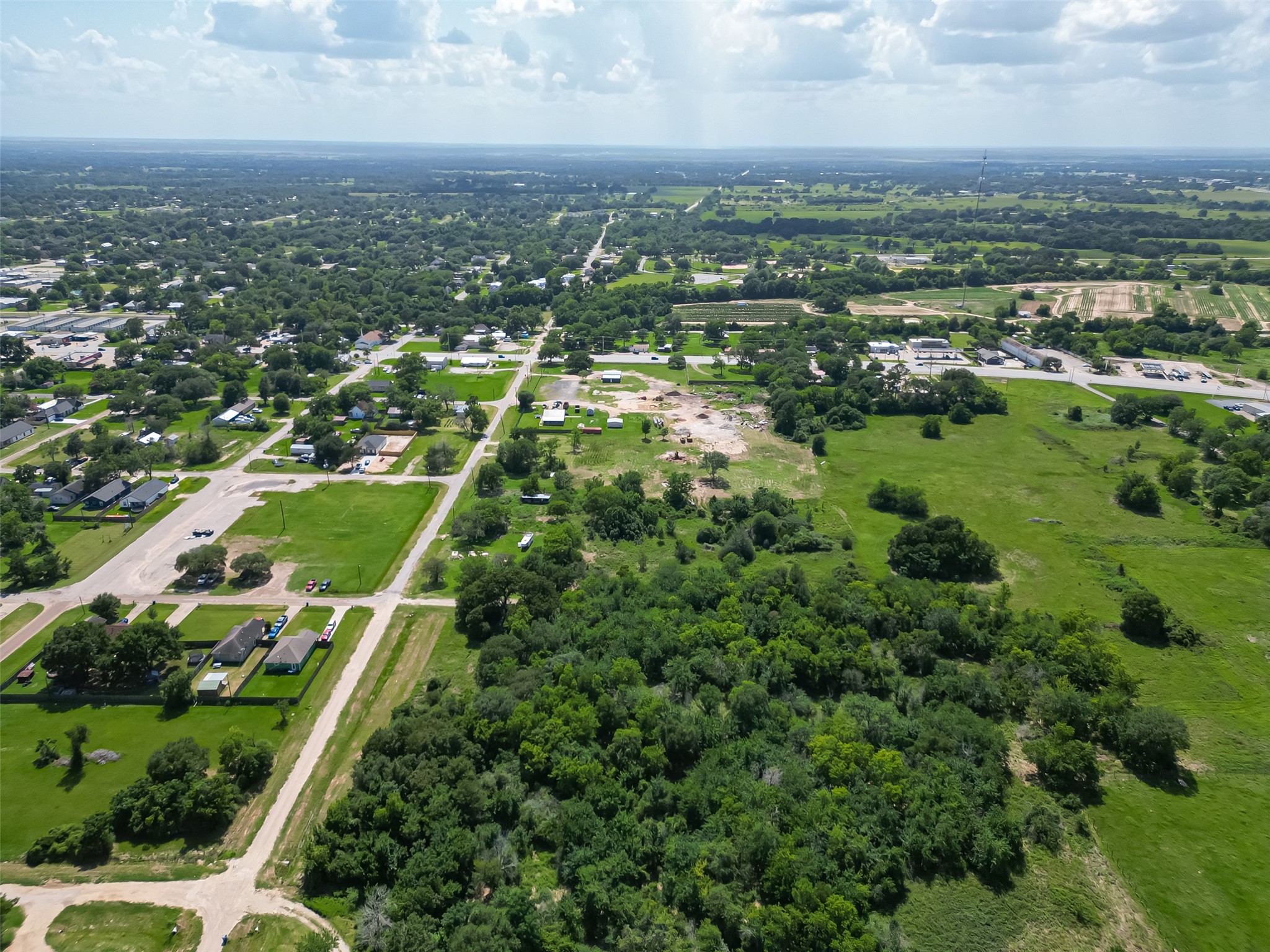 210 5th Street Hempstead, TX 77445 - Photo 32 of 36 an aerial view of residential houses with outdoor space and trees