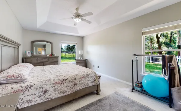 a bedroom with a bed and a large window