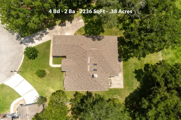 an aerial view of a house with a yard and lake view