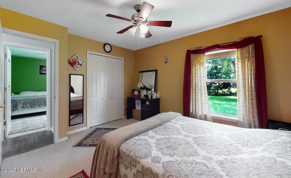 a bedroom with a large bed and a window