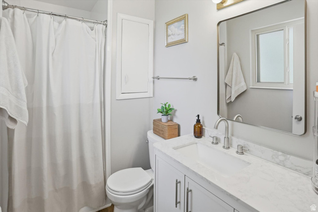 8938 Manchester Lane Sandy, UT 84093 - Photo 17 of 50 Bathroom featuring a white vanity with an integrated rectangular sink, a stone-finish countertop, and brushed nickel fixtures