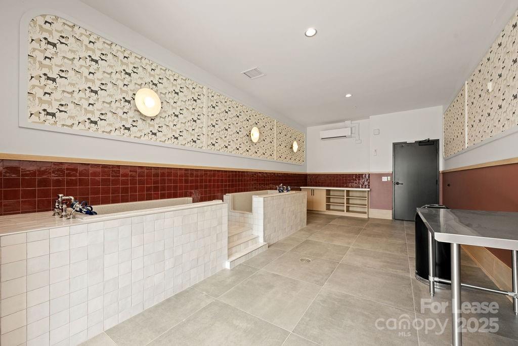 4101 Raleigh Street, Unit B1 Charlotte, NC 28206 - Photo 4 of 48 a kitchen with stainless steel appliances cabinets and wooden floor