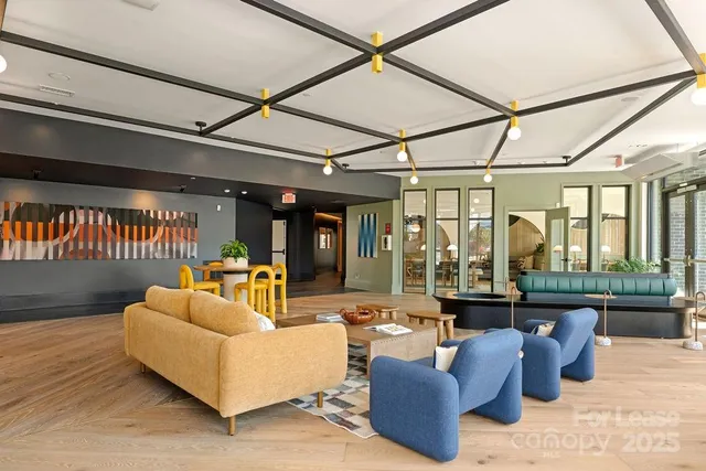 a living room with furniture and a floor to ceiling window