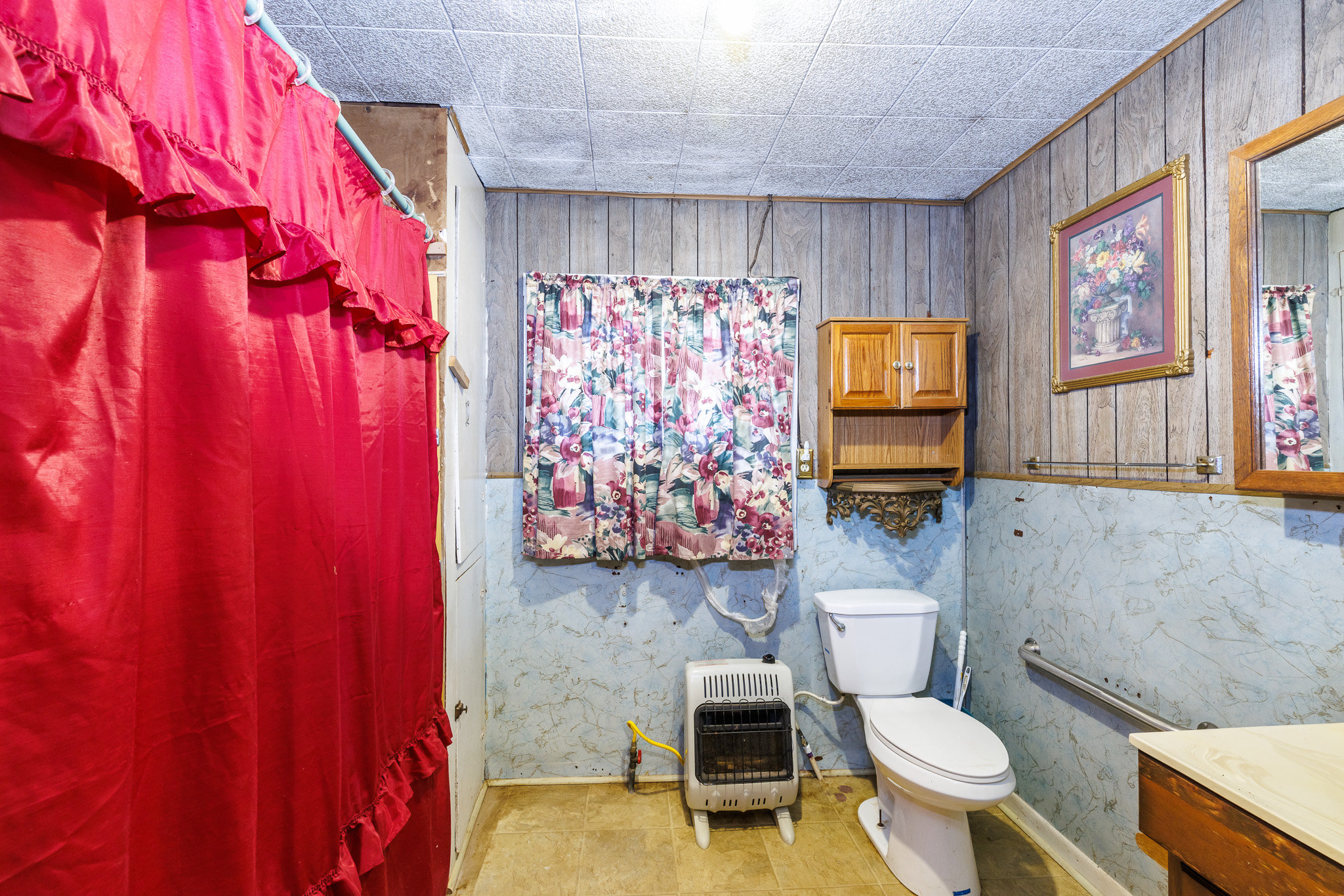 406 Carpenter Street Smiley, TX 78159 - Photo 11 of 17 a bathroom with a toilet a sink and a shower curtain