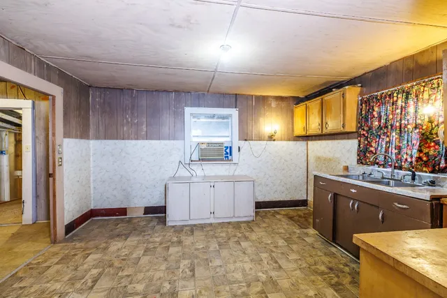 a kitchen with cabinets and window