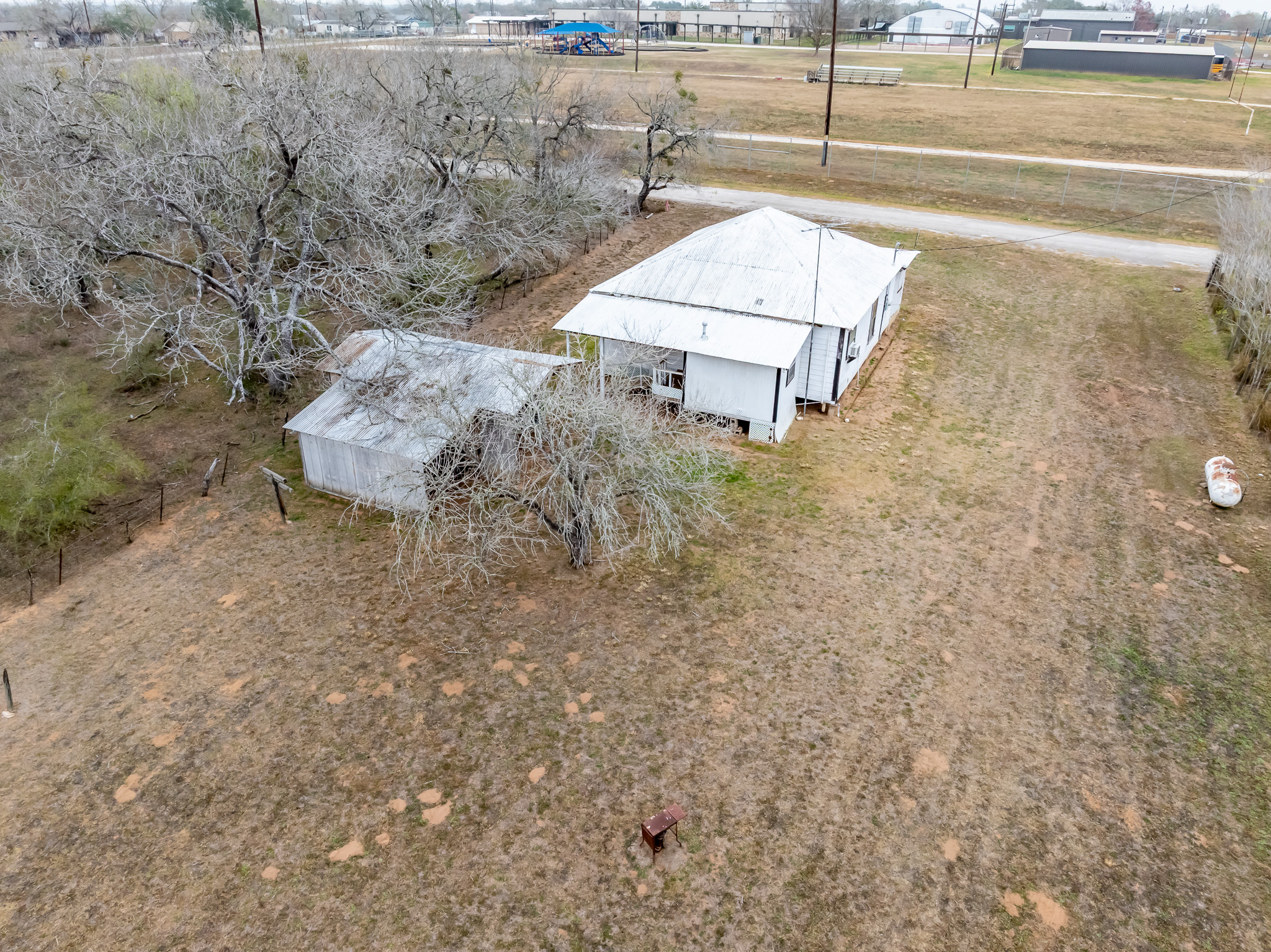 406 Carpenter Street Smiley, TX 78159 - Photo 3 of 17 a backyard of a house with a yard and outdoor seating