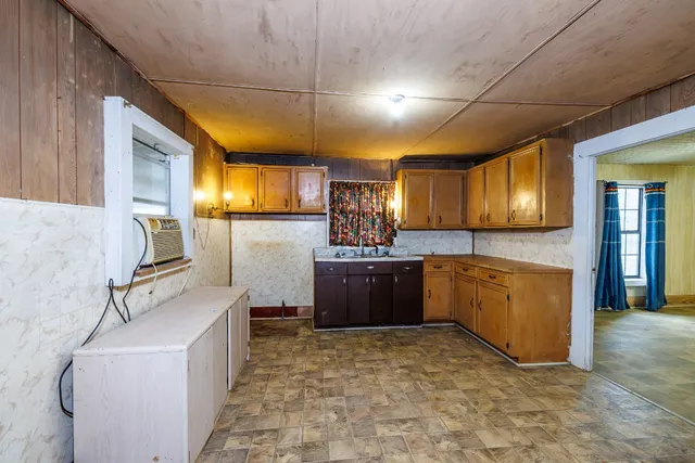 a kitchen with sink cabinets and appliances
